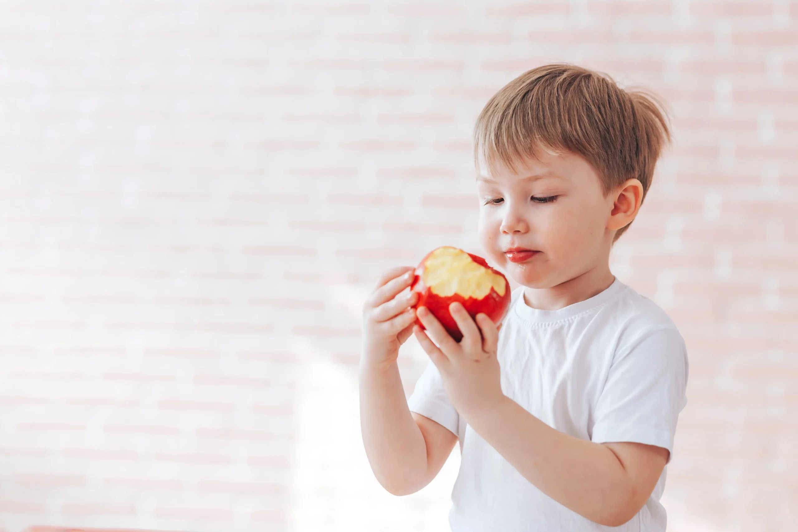 healthy boy chews apple