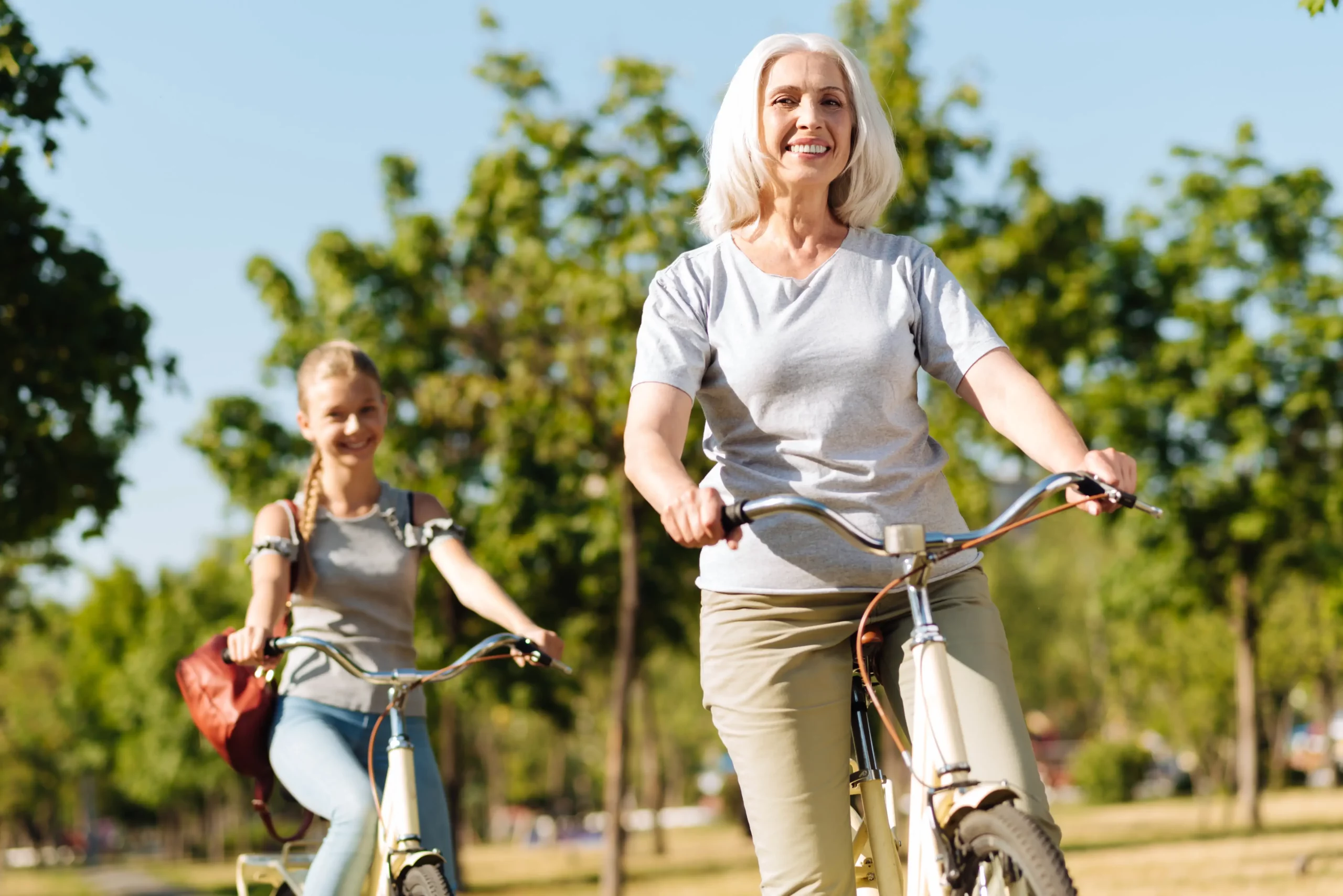 middle age woman riding bikes with young girl